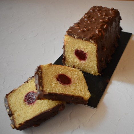 Holey Moley lemon surprise cake with raspbery insert and rocher chocolate glaçage